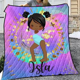 a girl holding up a purple and blue quilt