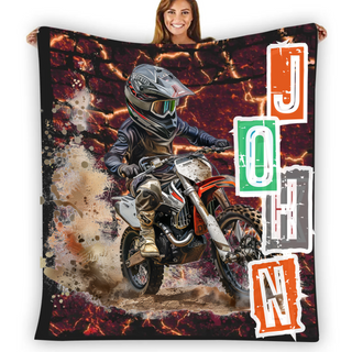 a woman holding a blanket with a picture of a motorcyclist on it