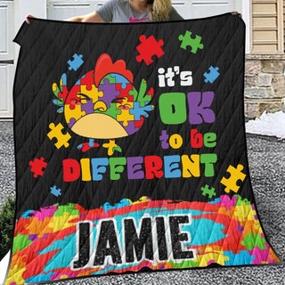 a woman is holding up a quilt that says it&#39;s ok to be different