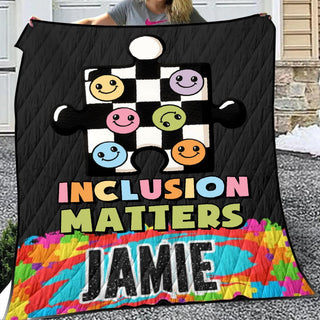 a woman holding up a quilt with a picture of a group of people on it