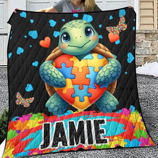 a woman holding a large blanket with a picture of a turtle holding a heart