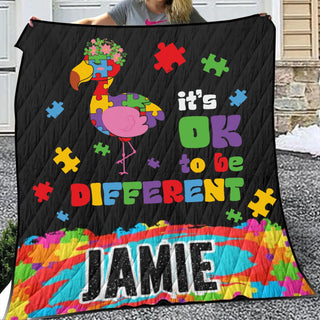 a woman holding a quilt with a picture of a bird on it