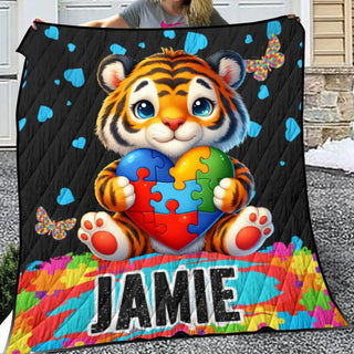 a young girl holding a large quilt with a picture of a tiger holding a puzzle