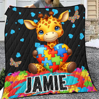 a young girl holding up a personalized giraffe quilt