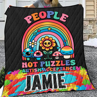 a woman holding up a quilt that says people not puzzles