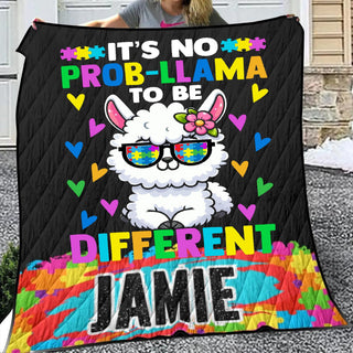 a woman holding a quilt with a llama wearing sunglasses