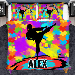 a bed with a colorful bed cover with a picture of a person doing a kick