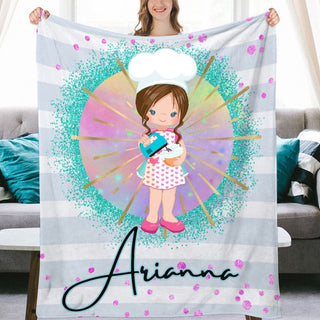 a woman holding up a personalized blanket