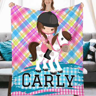 a girl is holding a blanket with a horse on it