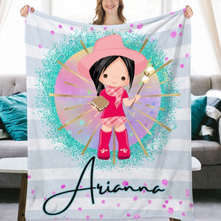 a woman holding up a personalized blanket