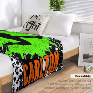 a bed with a green and black blanket on top of it