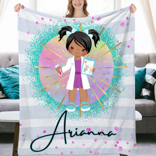 a woman holding up a personalized blanket