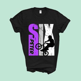 a black t - shirt with a purple design of a skateboarder