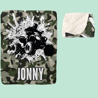 a green camo towel with a black and white picture of a person riding a