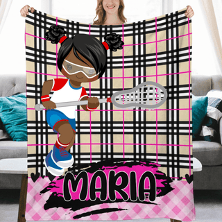 a woman holding up a blanket with a picture of a girl on it