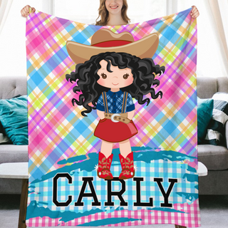 a girl holding up a personalized blanket