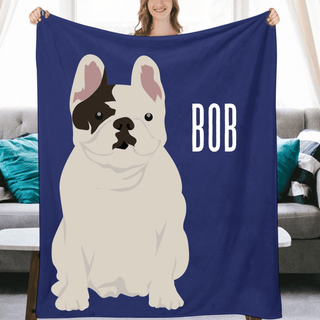 a woman holding up a blue blanket with a picture of a dog