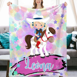 a girl holding a personalized blanket with a horse