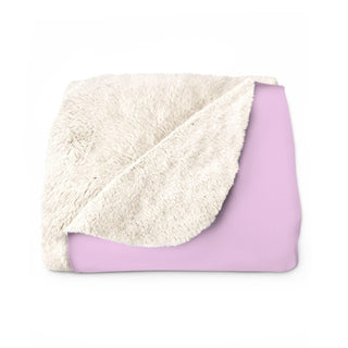 a pink and white blanket on a white background