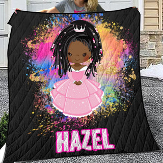 a woman holding up a blanket with a picture of a girl in a pink dress