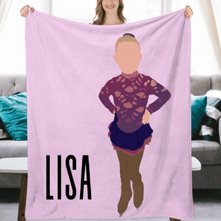 a woman holding up a pink blanket with a picture of herself