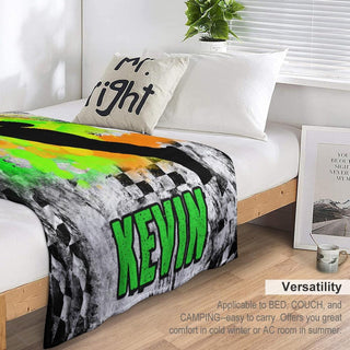 a bed with a green and black blanket on top of it