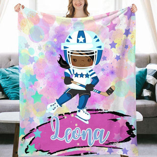 a girl holding a personalized blanket with a football player on it