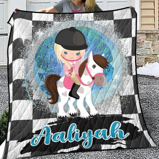 a girl is holding a blanket with a horse on it