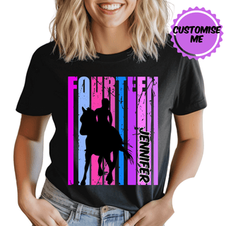 a woman wearing a black t - shirt with a picture of a horse and rider