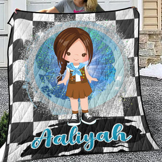 a girl holding up a blanket with a picture of her