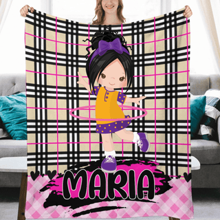 a woman holding up a blanket with a picture of a girl on it