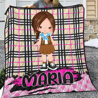 a girl holding a blanket with a picture of herself