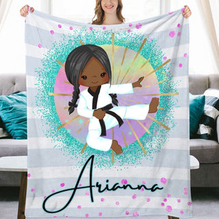 a woman holding up a personalized blanket