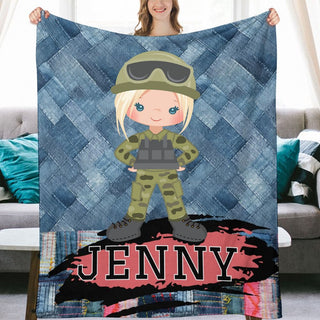 a woman holding up a blanket with a picture of a girl in a military uniform