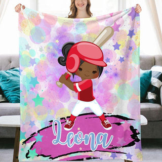 a girl holding up a personalized blanket with a baseball player on it