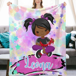 a girl holding up a personalized blanket