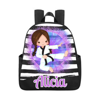 a black and white backpack with a girl doing karate