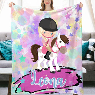 a girl is holding a personalized horse blanket