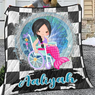 a woman holding a blanket with a picture of a mermaid on it