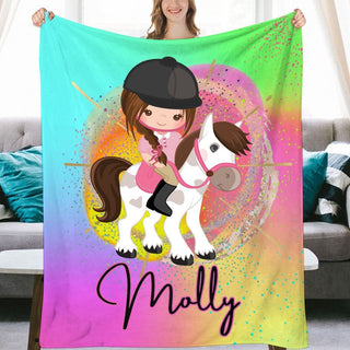 a woman holding a blanket with a horse on it