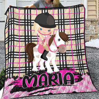 a girl riding a horse on a pink and black blanket