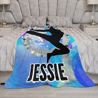 a bed covered in a blanket with a picture of a person jumping in the air