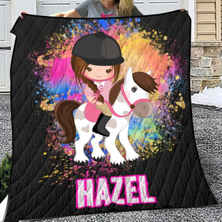 a girl is holding a blanket with a horse on it