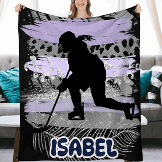 a woman holding a blanket with a picture of a hockey player