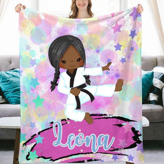 a woman holding up a personalized blanket