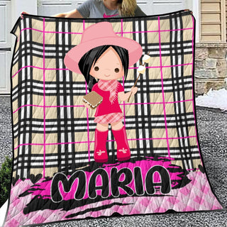 a woman holding a blanket with a picture of a girl on it