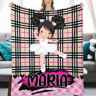 a woman holding a blanket with a picture of a ballerina on it