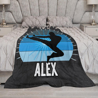 a bed with a blanket that has a picture of a person on it