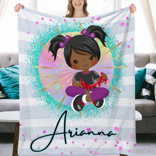 a girl holding up a personalized blanket