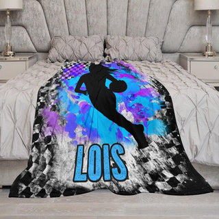 a bed with a blue and purple comforter and a black and white bed spread